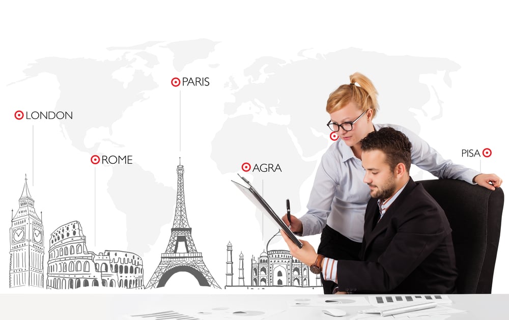 Young businessman and businesswoman with world map and major landmarks of the world